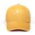 Front view of washed ginger baseball cap with a minimalist white dragonfly embroidery - Yellow