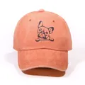 Washed cotton baseball cap in rust red featuring a minimalist pug graphic print - Orange