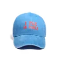 Washed blue denim baseball cap with I PEE IN POOLS red embroidery and curved brim - Blue