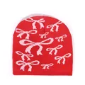 Red knitted beanie featuring pink bow patterns in a trendy streetwear style - One Size / Red