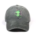 Dark grey washed denim baseball cap featuring a green alien embroidery design - Dark Green