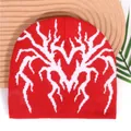 Y2K Red knit beanie featuring white heart spider jacquard pattern on a wooden surface - One Size / Red
