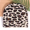 Leopard print knitted beanie for women with warm thick fabric on a wooden background - One Size / Beige