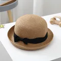 Detail of children's straw beach hat with dense weave and black ribbon bow decoration - S (52-54cm) / Khaki