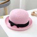 Children's pink woven straw hat with black ribbon and bow detail on white desk - S (52-54cm) / Pink