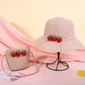 Detail of pink woven straw sun hat and matching bag with three 3D strawberry accents - Strawberry Style / Pink