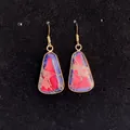 Detail of bohemian gold-rimmed trapezoid earrings with marbled pink and blue stones - 16x30mm / Marble