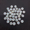Macro shot of 10mm white mother of pearl daisy beads with blue centers for jewelry making - Blue