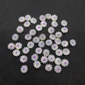 Macro detail of white shell daisy beads with purple centers on textured black background - 10mm / Purple