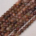 Detailansicht polierter Tigerauge- und Achatsteinperlen für die Schmuckherstellung - Rote Kaninchenhaar (6mm)