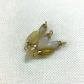 Set of six faceted bullet-shaped gemstone pendants with golden metal jump rings - Topaz