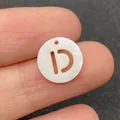 Natural white shell letter D bead with hollow design and iridescent luster - Letter D