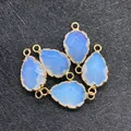 Light blue teardrop opal pendant with gold faceted edges and double connector rings - Opal