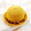 Bright yellow straw hat with a decorative brown floral band on a white pedestal - Adult Size (57cm) / Yellow