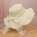 Elegant off-white woven straw sun hat featuring a large lace bow and wavy brim - M / Lace Style (Lace Bow) / Cream