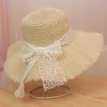 Beige wide brim straw hat with elegant white lace bow and wavy edge for sun protection - M / Lace Style (Lace Bow) / Beige