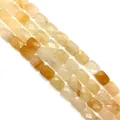 Macro view of rectangular faceted natural quartz beads in yellow and amber gradients - 8x11x15mm / Topaz