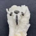 Macro shot of acrylic bull skull pendant with black diamond inlay on mineral crystals - Bright White with Black Rhinestone (No.4)