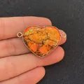 Macro detail of heart-shaped orange stone pendant with gold bezel and double loops - Orange Yellow Irregular Crack Heart Style (1)