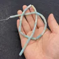 Handheld view of 5x13mm cylindrical natural stone beads in light blue turquoise finish - 5x13mm (ai-30 Pcs/Strand) / Light Blue (No.2)