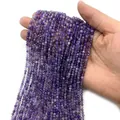 Strand of faceted amethyst purple gemstones for jewelry making held in hand - Amethyst
