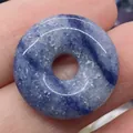 Blue sodalite stone donut pendant with white marbling held in hand for scale - Blue Vein Stone (No.10)