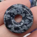 Polished snowflake obsidian donut pendant with unique natural white speckled patterns - Snowflake Obsidian