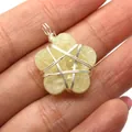 Handmade flower natural stone pendant with silver wire wrap star detail shown on palm - 20x27mm