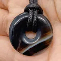 Purple natural agate donut pendant with white stripes on a black braided cord - Striped Black Agate