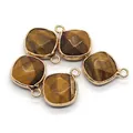 Detailed view of five diamond-cut tiger eye stone pendants with gold metal edge plating - Ribbon Edged / Tiger's Eye