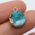 Round blue druzy crystal pendant with gold trim held by hand to show 15mm scale - Cyan-Blue Gradient