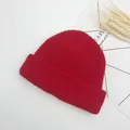 Detailed view of red ribbed knit beanie with thick texture and fold-over cuff design - One Size (Elastic Adjustable) / Red