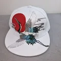 White flat brim baseball cap featuring detailed crane and red sun embroidery - Crane and Sun Embroidery (White)