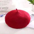 Classic dark red wool beret for women shown with stylish lifestyle accessories on table - One Size / Burgundy