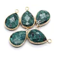 Detailed macro view of five teardrop lapis lazuli pendants with gold plated edges - Teal Spotted Style (No. 7)