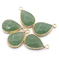 Macro view of five faceted green natural stone teardrop pendants with gold plated edges - Green Aventurine