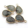 Detailed view of teardrop natural stone pendants with engraved Nordic runes and gold trim - Flash Stone (Labradorite)