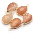 Five teardrop-shaped orange sunstone pendants with elegant gold plated metal borders - Pink Orange Stone (No. 18)