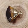 Tiger eye stone triangular pendant with gold-plated metal clasp on wooden background - Tiger's Eye