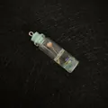 Mini glass bottle pendant with pink flowers and teal sequins on black background - Light Blue Cap (No.6)