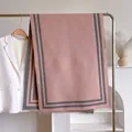 Detail of pink cashmere scarf with grey stripes, fringe edges, and soft knit texture - 180cm / Dusty Pink