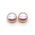 Close-up of a pair of natural pale pink button pearls with smooth metallic luster - 2.5-3mm / Purple