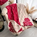Red and white camellia pattern cashmere scarf with classic plaid design and fringed edges - Red