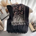 Ethnic black cashmere shawl featuring orange floral embroidery and long tassel fringe - 185cm / Black
