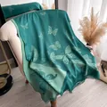 Detail of butterfly print pattern on dark green silk-like scarf with fringe edges - Green (TSM-075)