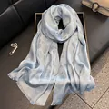 Detail of light blue scarf with subtle leopard jacquard pattern and shiny glitter texture - Blue