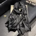 Elegant black long scarf with metallic silver shimmer, jacquard pattern and frayed edges - Black