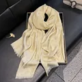 Champagne gold silk blend floral jacquard scarf with frayed fringe on a black display tray - Tsm-084 Beige