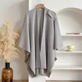 Classic grey knitted shawl with elegant drape and soft texture on wooden hanger - Gray