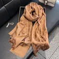 Elegant bronze leopard print silk scarf with golden shimmer and fringe details - Brown